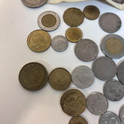 A VARIETY OF FOREIGN COINS AND PAPER CURRENCY