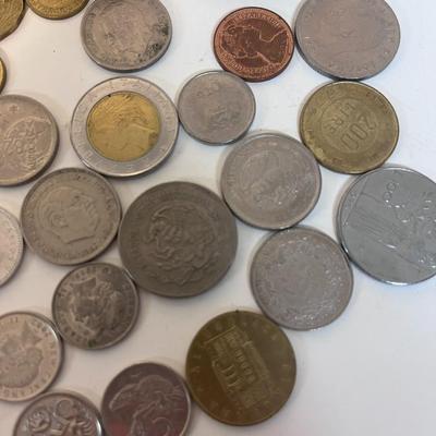 A VARIETY OF FOREIGN COINS AND PAPER CURRENCY