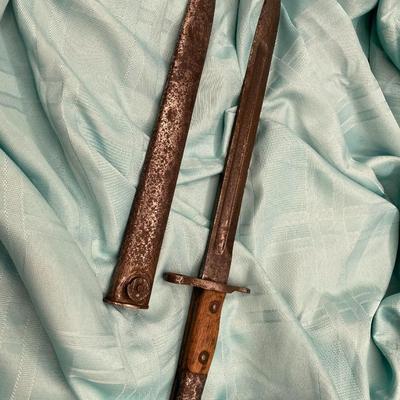 Sale Photo Thumbnail #134: With scabbard.  Stamped "U.S."
wood and metal grip
wear is typical with age
17.25 inches with scabbard