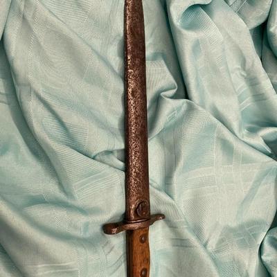 Sale Photo Thumbnail #133: With scabbard.  Stamped "U.S."
wood and metal grip
wear is typical with age
17.25 inches with scabbard