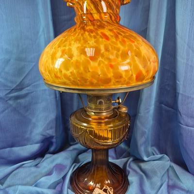 Sale Photo Thumbnail #155: 19.5 inches tall
Mottled amber glass ruffled/scalloped at the top.
Amber glass base with swag decoration
Aladdin burner assembly 
very good condition