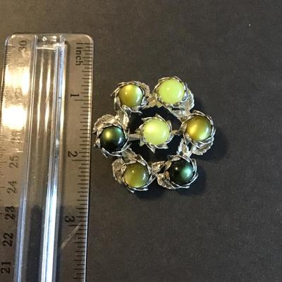 Sale Photo Thumbnail #106: Vintage chartreuse lucite or cabochons set in silver tone leaf-motif metal base 
Please see attached photos