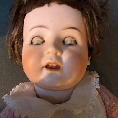 Sale Photo Thumbnail #199: Bisque/porcelain doll made in the Thuringa region of Germany.
Features open and close eyes, composition body, bisque limbs
B 5  - 4 3/4 
good condition