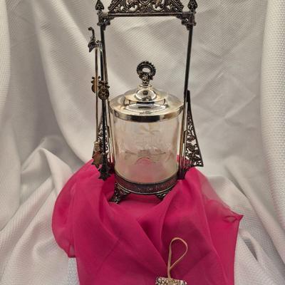 Sale Photo Thumbnail #205: Ornate Victorian silver plate stand with tongs and clear etched crystal container, the lid may not be original.