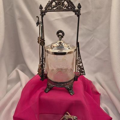 Sale Photo Thumbnail #206: Ornate Victorian silver plate stand with tongs and clear etched crystal container, the lid may not be original.
