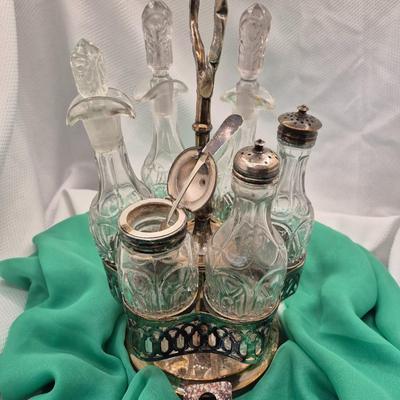 Sale Photo Thumbnail #208: Lovely old caddy for vinegar, oil, salt, pepper, mustard, etc. 
6 containers, 13.5 inches tall
Fair condition