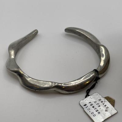 Pewter cuff bracelet and Trifari bracelet