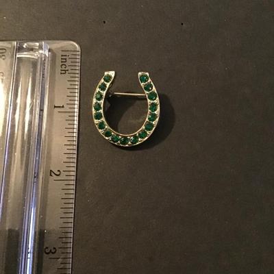 Sale Photo Thumbnail #177: Vintage Gold Tone horse shoe brooch with green emerald rhinestones Please see attached photos