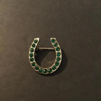 Sale Photo Thumbnail #176: Vintage Gold Tone horse shoe brooch with green emerald rhinestones Please see attached photos