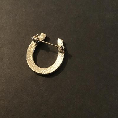 Sale Photo Thumbnail #178: Vintage Gold Tone horse shoe brooch with green emerald rhinestones Please see attached photos