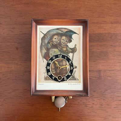 LOT 45: Pair of Miniature Wall Clocks (M.I. Hummel Stormy ARS Sacra 9743 / Plastic Battery Operated with Four Pine Cone Weights