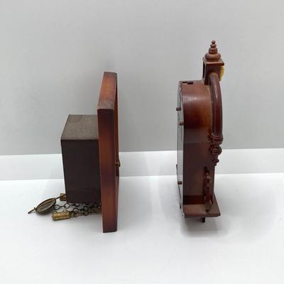 LOT 45: Pair of Miniature Wall Clocks (M.I. Hummel Stormy ARS Sacra 9743 / Plastic Battery Operated with Four Pine Cone Weights