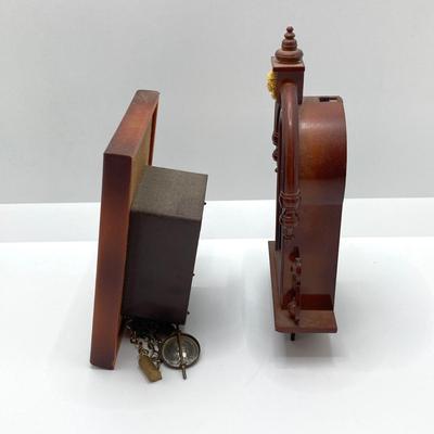 LOT 45: Pair of Miniature Wall Clocks (M.I. Hummel Stormy ARS Sacra 9743 / Plastic Battery Operated with Four Pine Cone Weights