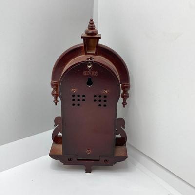 LOT 45: Pair of Miniature Wall Clocks (M.I. Hummel Stormy ARS Sacra 9743 / Plastic Battery Operated with Four Pine Cone Weights