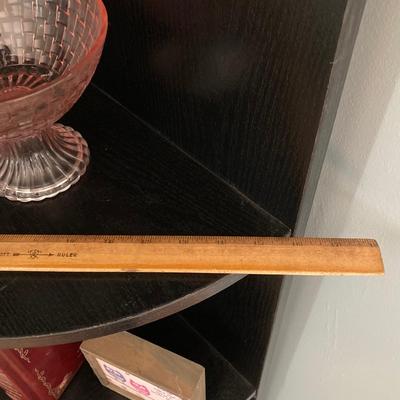 LOT 63: Black Corner Shelf Unit with Home Decor - Mirror, Candle Holder, Pink Glass Bowl, Sir Arthur Conan Doyle Book and More