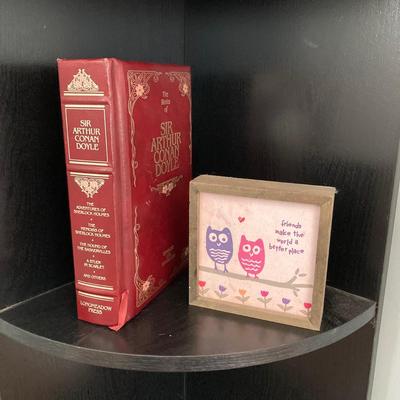 LOT 63: Black Corner Shelf Unit with Home Decor - Mirror, Candle Holder, Pink Glass Bowl, Sir Arthur Conan Doyle Book and More