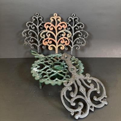 LOT 94: Vintage Family Tree Cast Iron Trivets, Vintage Black Cast Iron Footed T-15 Butterfly Trivet & a Green Enamel Old Dutch Design...