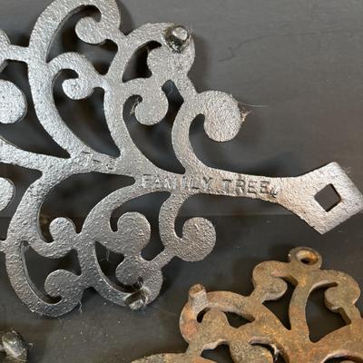 LOT 94: Vintage Family Tree Cast Iron Trivets, Vintage Black Cast Iron Footed T-15 Butterfly Trivet & a Green Enamel Old Dutch Design...