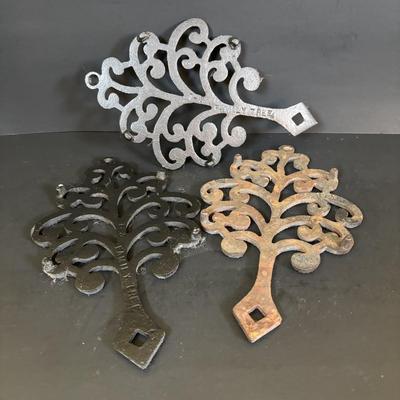 LOT 94: Vintage Family Tree Cast Iron Trivets, Vintage Black Cast Iron Footed T-15 Butterfly Trivet & a Green Enamel Old Dutch Design...
