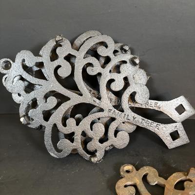 LOT 94: Vintage Family Tree Cast Iron Trivets, Vintage Black Cast Iron Footed T-15 Butterfly Trivet & a Green Enamel Old Dutch Design...