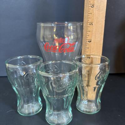 LOT 114: Black & White Framed Photos of Store Fronts, Ande Rooney Metal Sign, Coca-Cola Glasses, 1993 Coca-Cola Vending Machine...