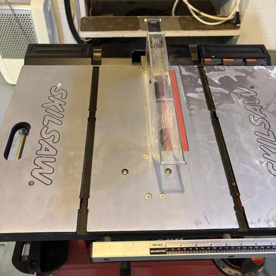 LOT 172: Skil 10-inch Table Saw on Stand & Adjustable Rolling Stand