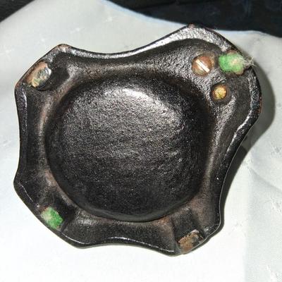 Sale Photo Thumbnail #10: This amazing ashtray features a young gentleman hanging on to the lamp post as he dances in the Rain like Fred Astaire. Good condition with some discoloration to the front as pictured