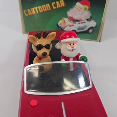 LOT 86: Gemmy Animated Musical Lowrider Car with Santa and Reindeer, Son Ai Santa Claus Cartoon Car Christmas Retro Vintage Toy in Box,...
