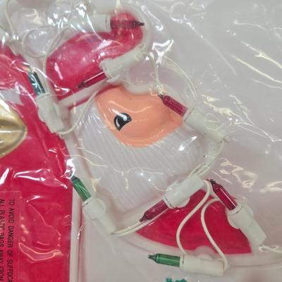 LOT 92: Two Lighted Santa Claus Christmas Window Decor, Two Miniature Noel Candle Trains, and Jolly St Nick Collection Two Jovial Holiday...