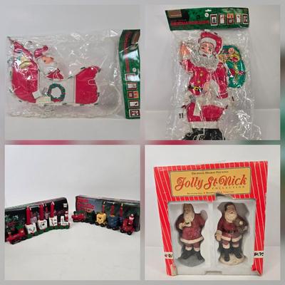 LOT 92: Two Lighted Santa Claus Christmas Window Decor, Two Miniature Noel Candle Trains, and Jolly St Nick Collection Two Jovial Holiday...