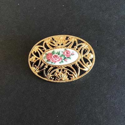Sale Photo Thumbnail #198: Vintage Avon pastel oval brooch with gold tone filigree and a white porcelain insert featuring pink roses Please see attached photos
