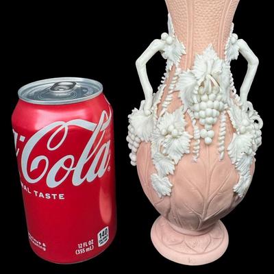 Sale Photo Thumbnail #463: Jasperware is a fine, unglazed stoneware known for its matte finish and high relief white accents. This piece is possibly Victorian, made by Bennington. There is one small chip on the crown, and some leaves are broken. Measurement: 7.5”H x 3.5”W. [BK]