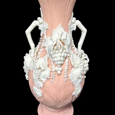 Sale Photo Thumbnail #462: Jasperware is a fine, unglazed stoneware known for its matte finish and high relief white accents. This piece is possibly Victorian, made by Bennington. There is one small chip on the crown, and some leaves are broken. Measurement: 7.5”H x 3.5”W. [BK]