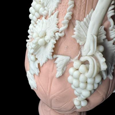 Sale Photo Thumbnail #465: Jasperware is a fine, unglazed stoneware known for its matte finish and high relief white accents. This piece is possibly Victorian, made by Bennington. There is one small chip on the crown, and some leaves are broken. Measurement: 7.5”H x 3.5”W. [BK]