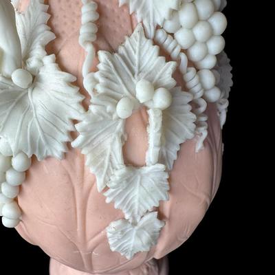 Sale Photo Thumbnail #466: Jasperware is a fine, unglazed stoneware known for its matte finish and high relief white accents. This piece is possibly Victorian, made by Bennington. There is one small chip on the crown, and some leaves are broken. Measurement: 7.5”H x 3.5”W. [BK]