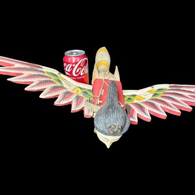 Sale Photo Thumbnail #491: Garuda is a mythical divine bird in Hindu mythology. This has wood construction, with removable wings. Measurement: 18”L x 20.5”W. Pre-auction estimate: $25-$50. [BK]