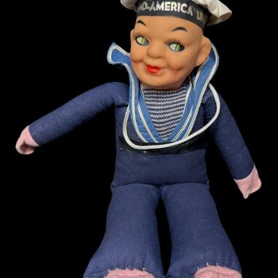 Sale Photo Thumbnail #581: This has a cloth body with a composite head. It is possibly made by Norah Wellings. It was a souvenir or memento of a cruise. There is some age related wear. Measurement: 10”H. [BK]