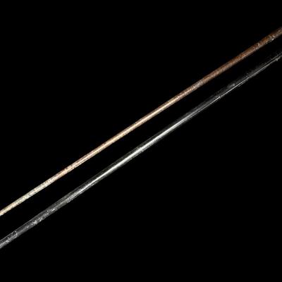 Sale Photo Thumbnail #592: Includes a leather wrapped walking stick with brass tip, and a believed to be mid-century cane with a lucite pommel. Age related wear. Measurement of longest: 37.5”L. [PT]