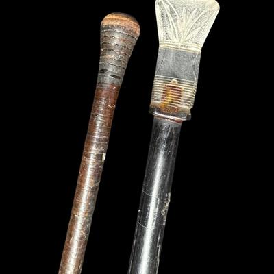 Sale Photo Thumbnail #593: Includes a leather wrapped walking stick with brass tip, and a believed to be mid-century cane with a lucite pommel. Age related wear. Measurement of longest: 37.5”L. [PT]