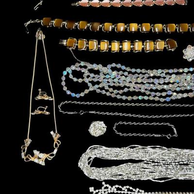 Sale Photo Thumbnail #595: Includes gold tone, silver tone, rhinestones, beads, crystals, and more. These ensembles include a combination of necklaces, bracelets, and/or earrings. Total of eight sets. [BK]