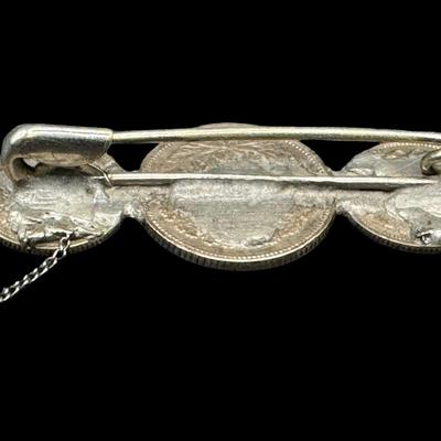 Sale Photo Thumbnail #607: [9.20g] This piece features three coins, mounted on a pin. The pin appears to have been replaced, and the piece may or may not be complete. The weight is overall. Silver content confirmed using Niton XRF precious metals analyzer. Measurement: 1 7/8”L. [