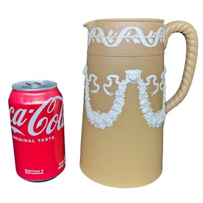 Sale Photo Thumbnail #609: Dudson was a 19th century competitor of Wedgwood. This is unglazed stoneware with applied white neoclassical reliefs. There is one small chip on the base. Measurement: 8”H x 5.5”W at base. Pre-auction estimate: $25-$50. [BK]