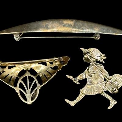 Sale Photo Thumbnail #618: [20.67g] Includes a black onyx and marcasite brooch, a brooch made in Mexico that depicts a young girl, and more. Total of three pieces. Measurement of longest: 3.5”L. Silver content confirmed using Niton XRF precious metals analyzer. [BK]