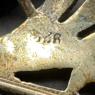 Sale Photo Thumbnail #620: [20.67g] Includes a black onyx and marcasite brooch, a brooch made in Mexico that depicts a young girl, and more. Total of three pieces. Measurement of longest: 3.5”L. Silver content confirmed using Niton XRF precious metals analyzer. [BK]