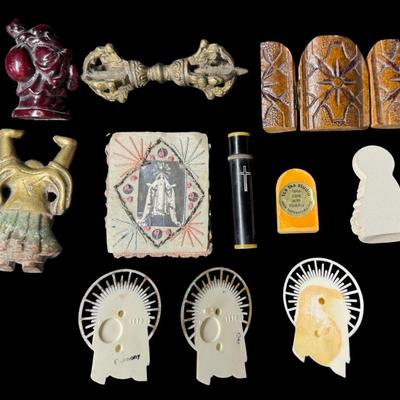 Sale Photo Thumbnail #627: Includes a resin Buddha, a brass Buddha, Virgin Mary icons, a tri-fold Orthodox plaque, and more. Total of ten pieces. Measurement of longest: 3.5”L. [BK]