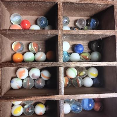SECTIONED WOODEN BOX WITH A VARIETY OF MARBLES