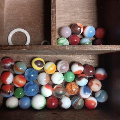 SECTIONED WOODEN BOX WITH A VARIETY OF MARBLES