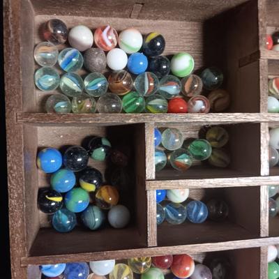 SECTIONED WOODEN BOX WITH A VARIETY OF MARBLES