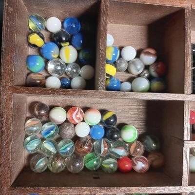 SECTIONED WOODEN BOX WITH A VARIETY OF MARBLES