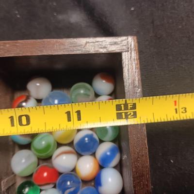 SECTIONED WOODEN BOX WITH A VARIETY OF MARBLES